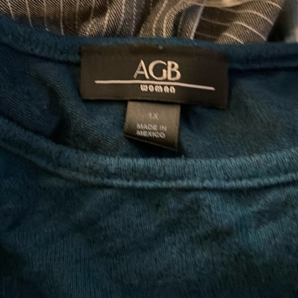 Bluish green sweater, light buttons on the side